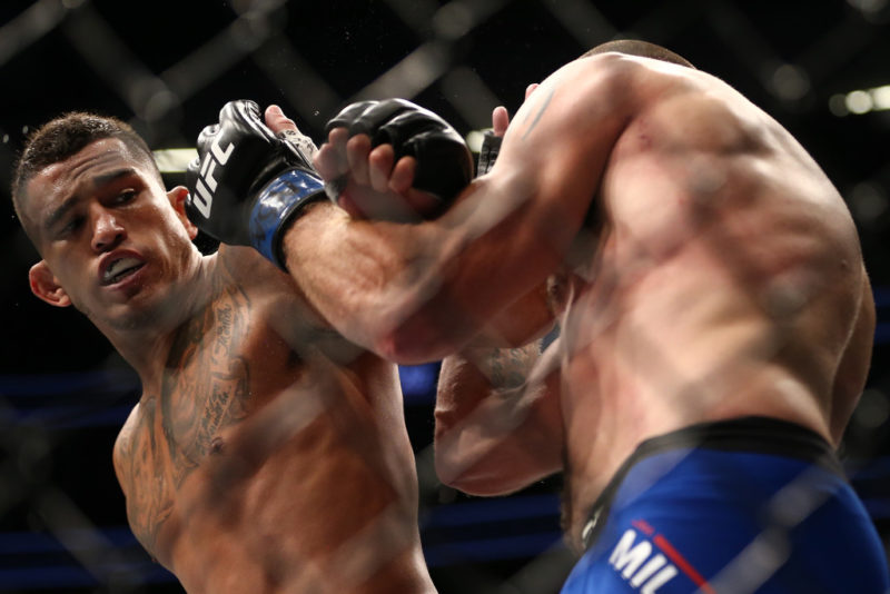 (L-R) Anthony Pettis punches Jim Miller in their lightweight bout during the UFC 213 event
