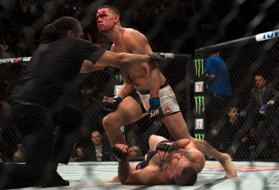 Nate Diaz stands after defeating Conor McGregor