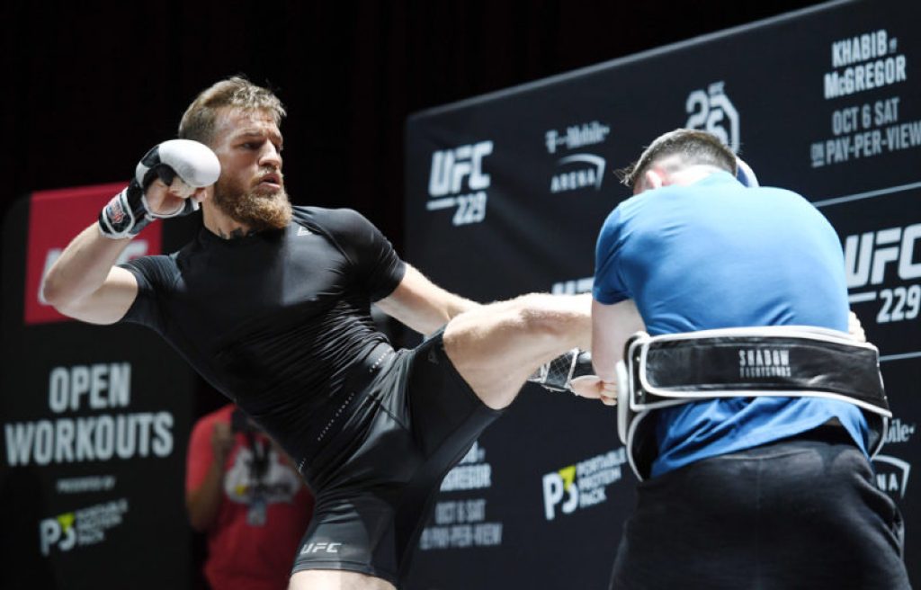 Conor McGregor (L) spars with his striking coach Owen Roddy during an open workout for UFC 229