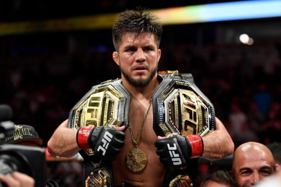 Henry Cejudo wears two titles after winning at UFC 238