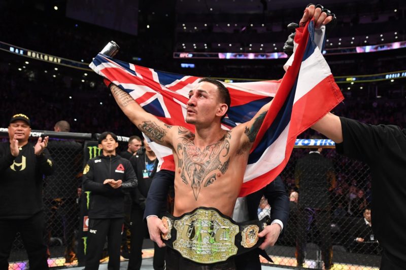 Max Holloway celebrates after winning his UFC Championship bout