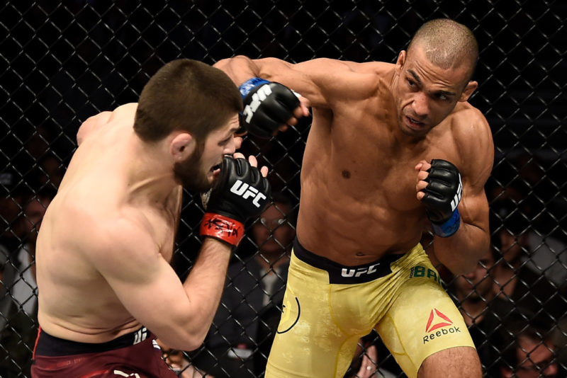 Edson Barboza of Brazil punches Khabib Nurmagomedov of Russia in their lightweight bout during the UFC 219