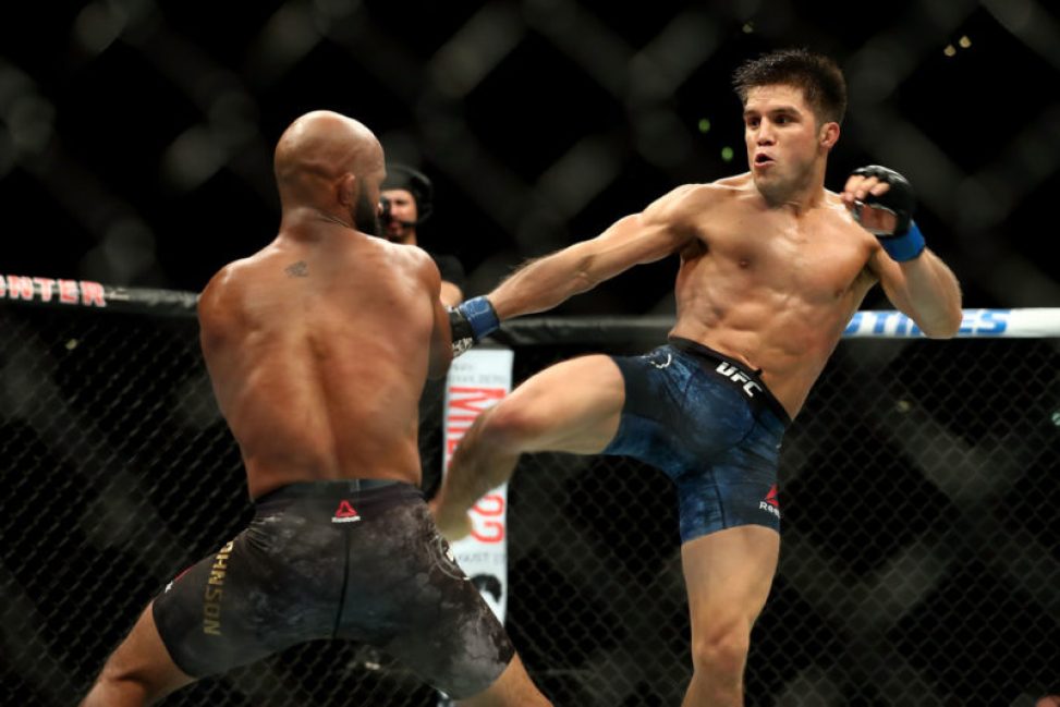 Henry Cejudo kicks Demetrious Johnson in the second round of the UFC Flyweight Title Bout during UFC 227