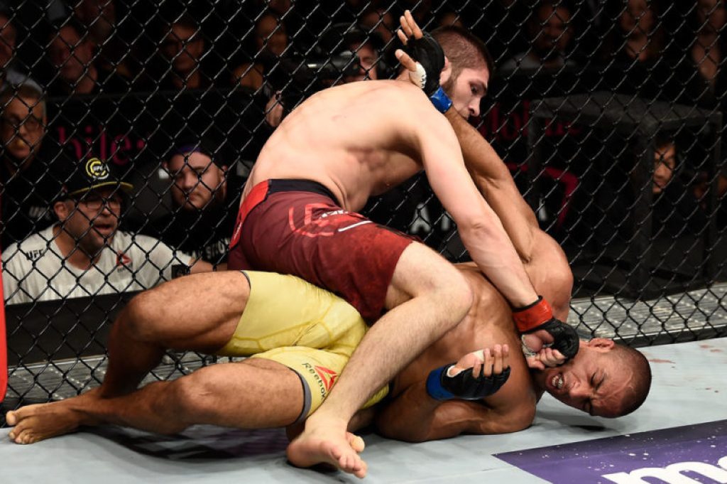 Khabib Nurmagomedov of Russia punches Edson Barboza of Brazil in their lightweight bout during UFC 219