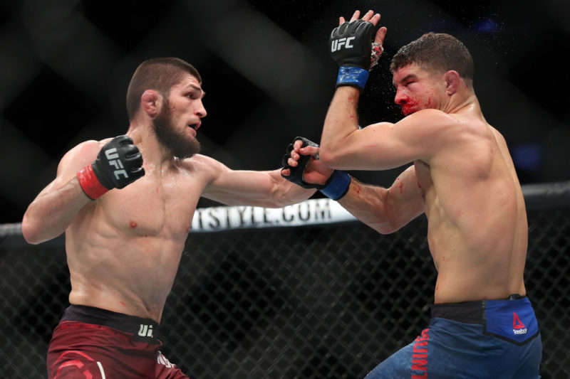 Khabib Nurmagomedov (L) throws a left hand to the head of Al Iaquinta (R) during their UFC lightweight championship bout at UFC 223