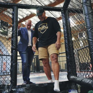 Loren Mack and Ray Sefo talk while exiting a cage