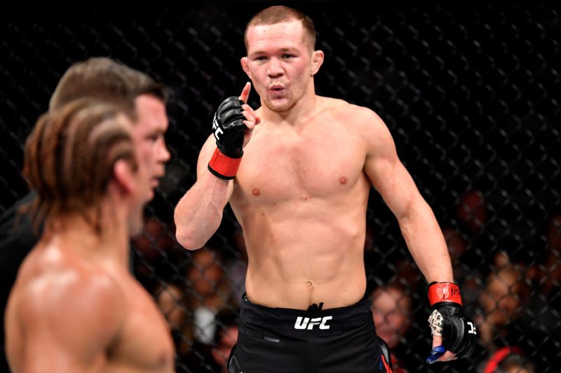 Petr Yan gestures to Urijah Faber during their contest at UFC 245