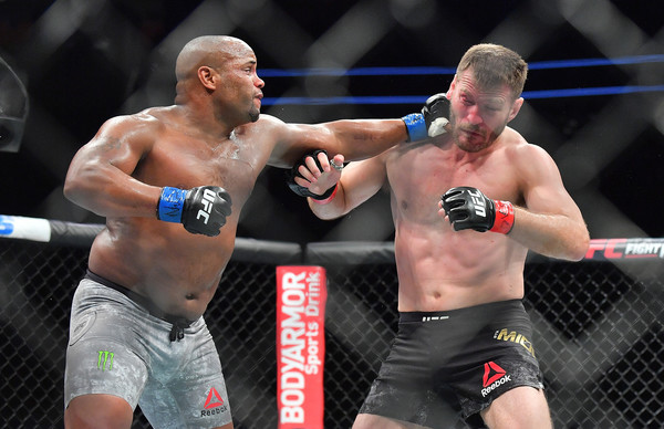 Daniel Cormier (L) lands a punch against Stipe Miocic during their heavyweight championship fight