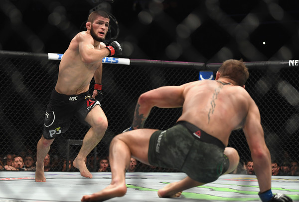 Khabib Nurmagomedov of Russia (L) chases down Conor McGregor of Ireland in their UFC lightweight championship bout